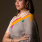 This is image of formal office wear saree which is in Grey-Yellow Border-pink & Green buttas Saree