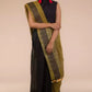 A zoomed out view of women wearing a Black Pure Linen Saree with Tints of Mustard, formal dress for women