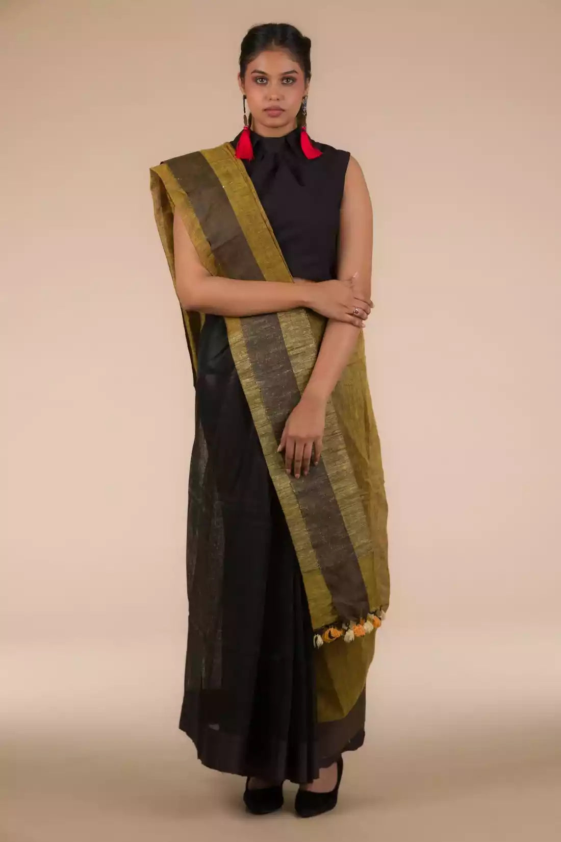 A zoomed out view of women wearing a Black Pure Linen Saree with Tints of Mustard, formal dress for women