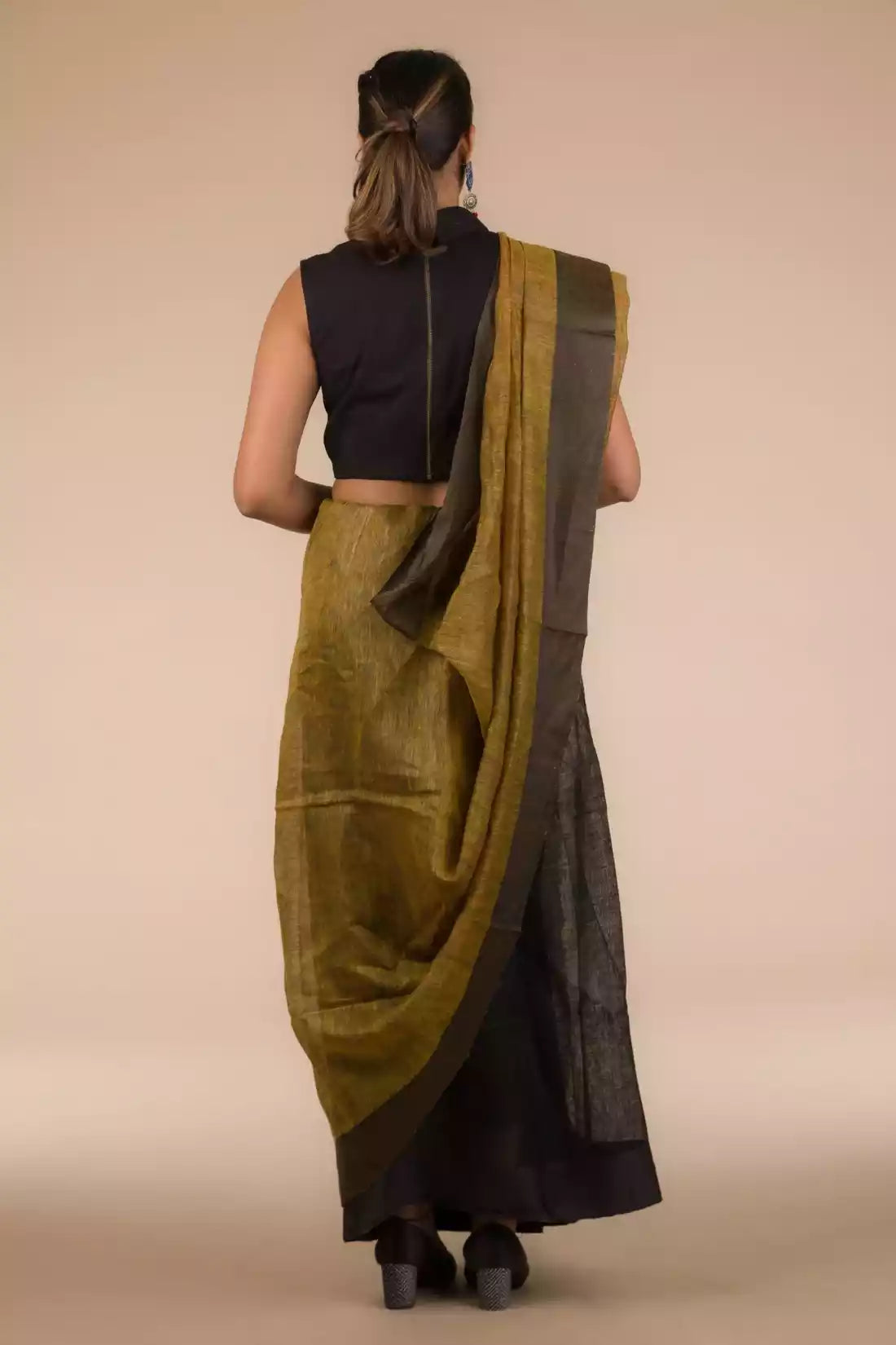 A beautiful back view of lady in Black Pure Linen Saree with Tints of Mustard, womens workwear