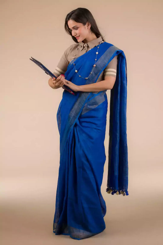 An aesthetic image of lady in Indy Pure Linen Saree in Royal Blue, womens workwear looking sinto the file