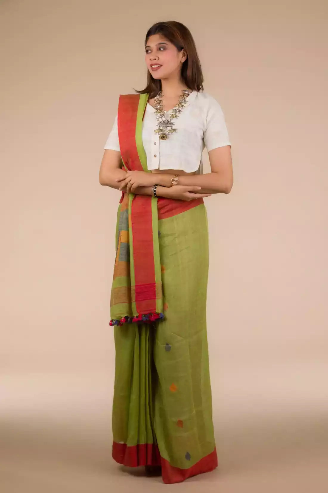 a woman looking sideways wearing formal workwear Parrot Green Jamdani Pure Linen Saree
