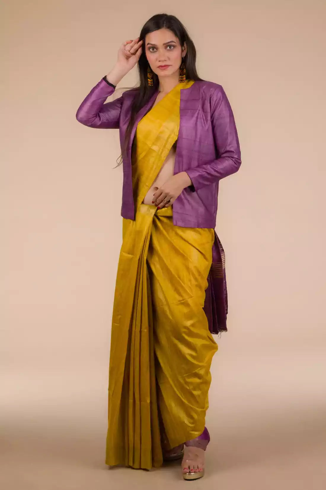 A beautiful lady in Mustard with purple border Plain In Pure Tussar with Ghicha Border Saree, who is also wearing a formal blazer for women