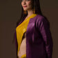a woman looking sideways wearing formal workwear for women which is Mustard with purple border Plain In Pure Tussar with Ghicha Border Saree