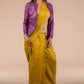 Aesthetically pleasing picture of a lady in Mustard with purple border Plain In Pure Tussar with Ghicha Border Saree