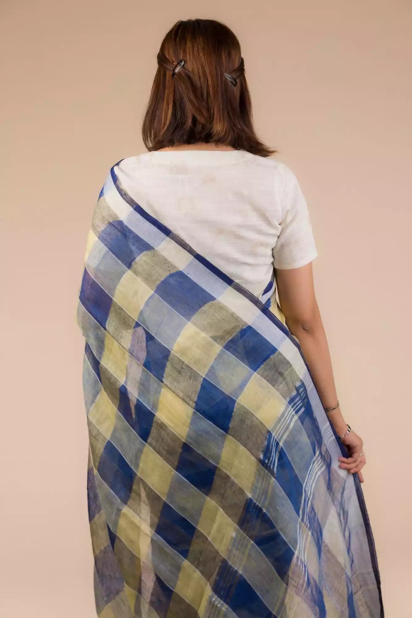 A beautiful back view of lady in Pure Linen Dark Blue Saree with Tan Brown and Lemon Yellow Checks, womens workwear