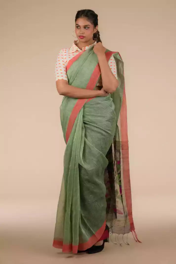 A beautiful lady in Pista green with jamdani pallu In Silk Linen Saree, a office wear for women
