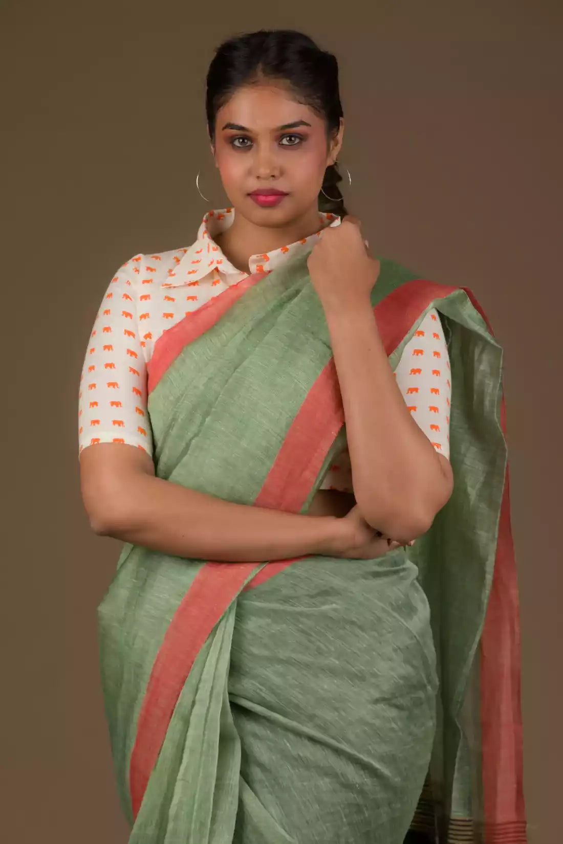 Aesthetically pleasing picture of a lady in a Pista green with jamdani pallu In Silk Linen Saree