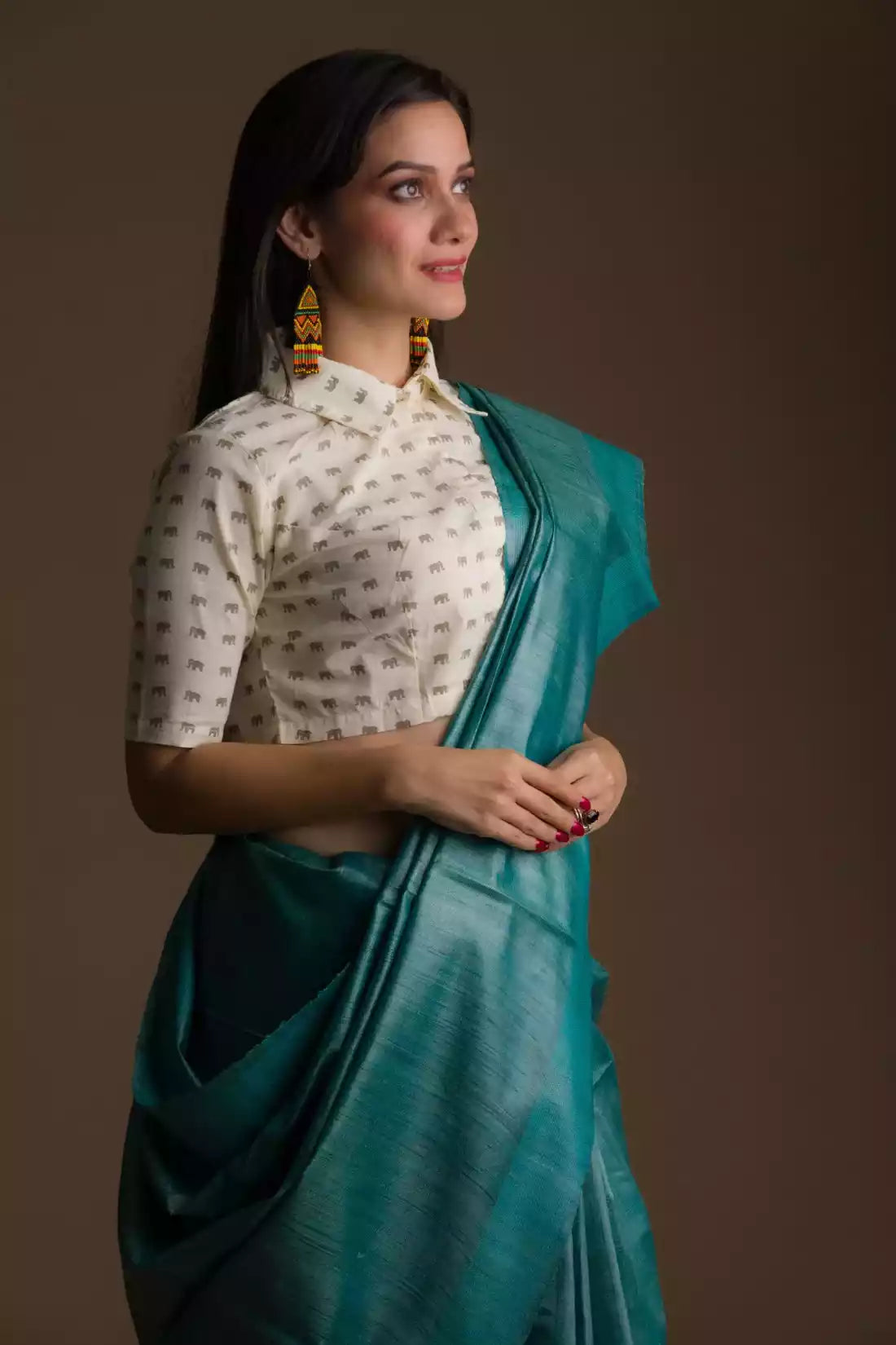 Aesthetically pleasing picture of a lady in a Sea green Plain In Pure Tussar Saree 