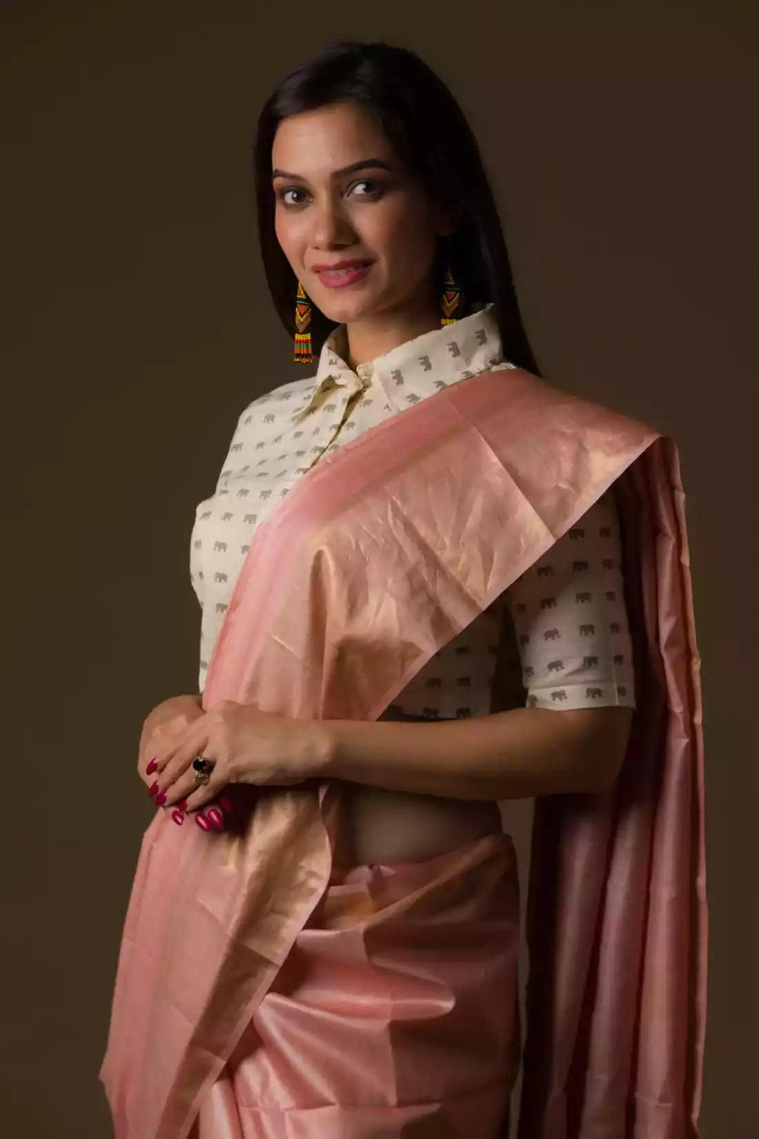Aesthetically pleasing picture of a lady in a Dusty Rose Plain In Tussar Munga Saree