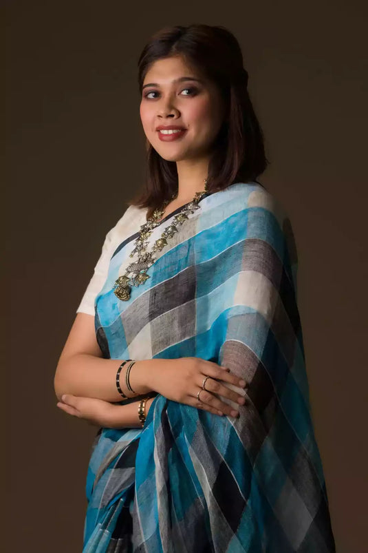 This is image of formal office wear saree which is  in Blue Black checks 