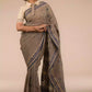 An aesthetic image of lady in Dark Beige & Black Woven Linen Cotton Saree, womens workwear looking sideways