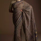 A zoomed out view of women wearing a Dark Beige & Black Woven Linen Cotton Saree, formal dress for women
