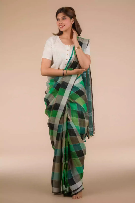 front view of a beautiful woman with short hair wearing green checks saree with off-white blouse