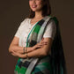 closure side view of a beautiful woman with short hair wearing green checks saree with off-white blouse