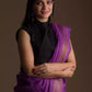 a beautiful woman wearing a purple saree with black blouse and gold accents on the border, and hands being folded