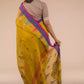 This is view from back of the mustard with blue and pink border Jamdani hand weaving Saree, formal office wear for women