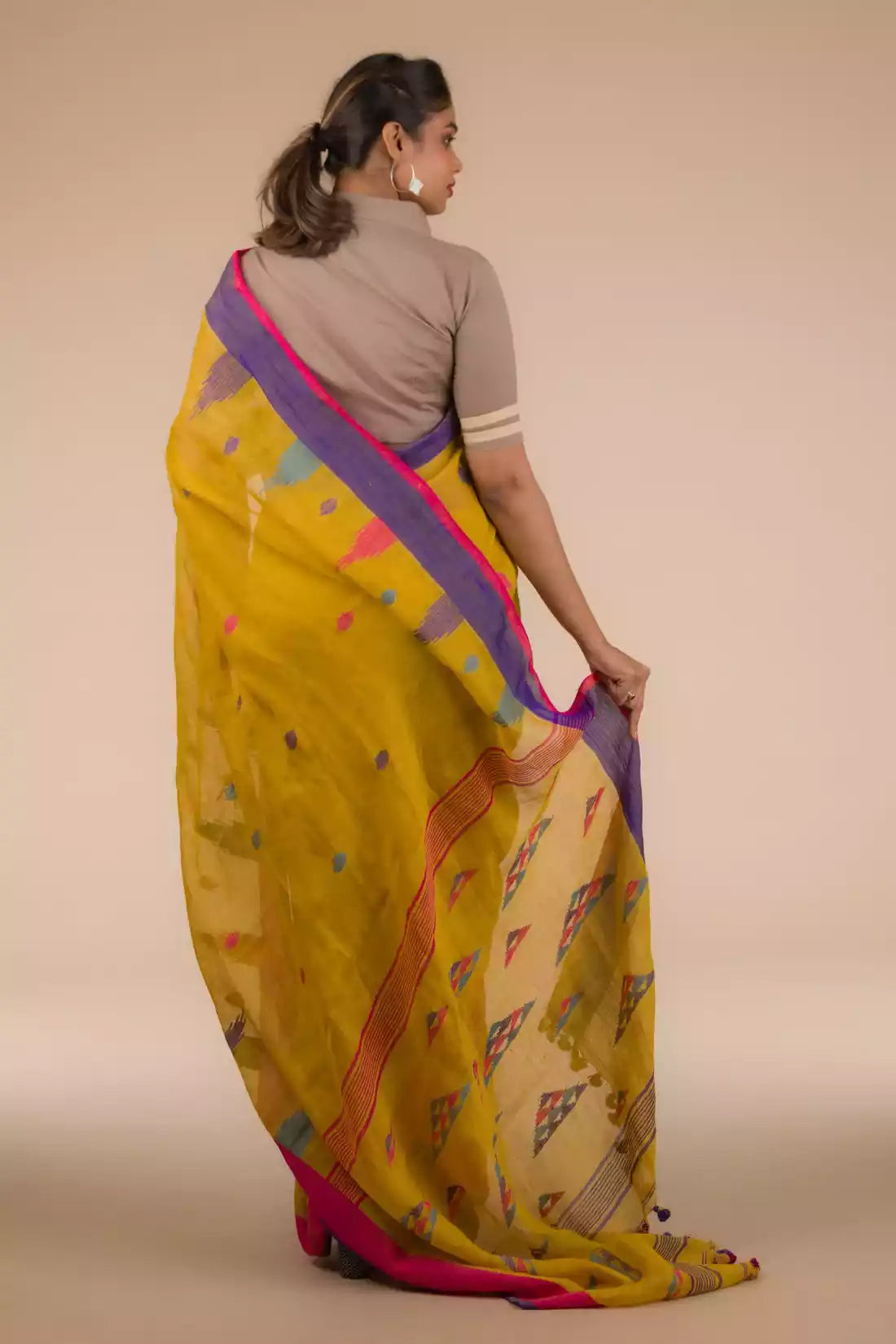 This is view from back of the mustard with blue and pink border Jamdani hand weaving Saree, formal office wear for women