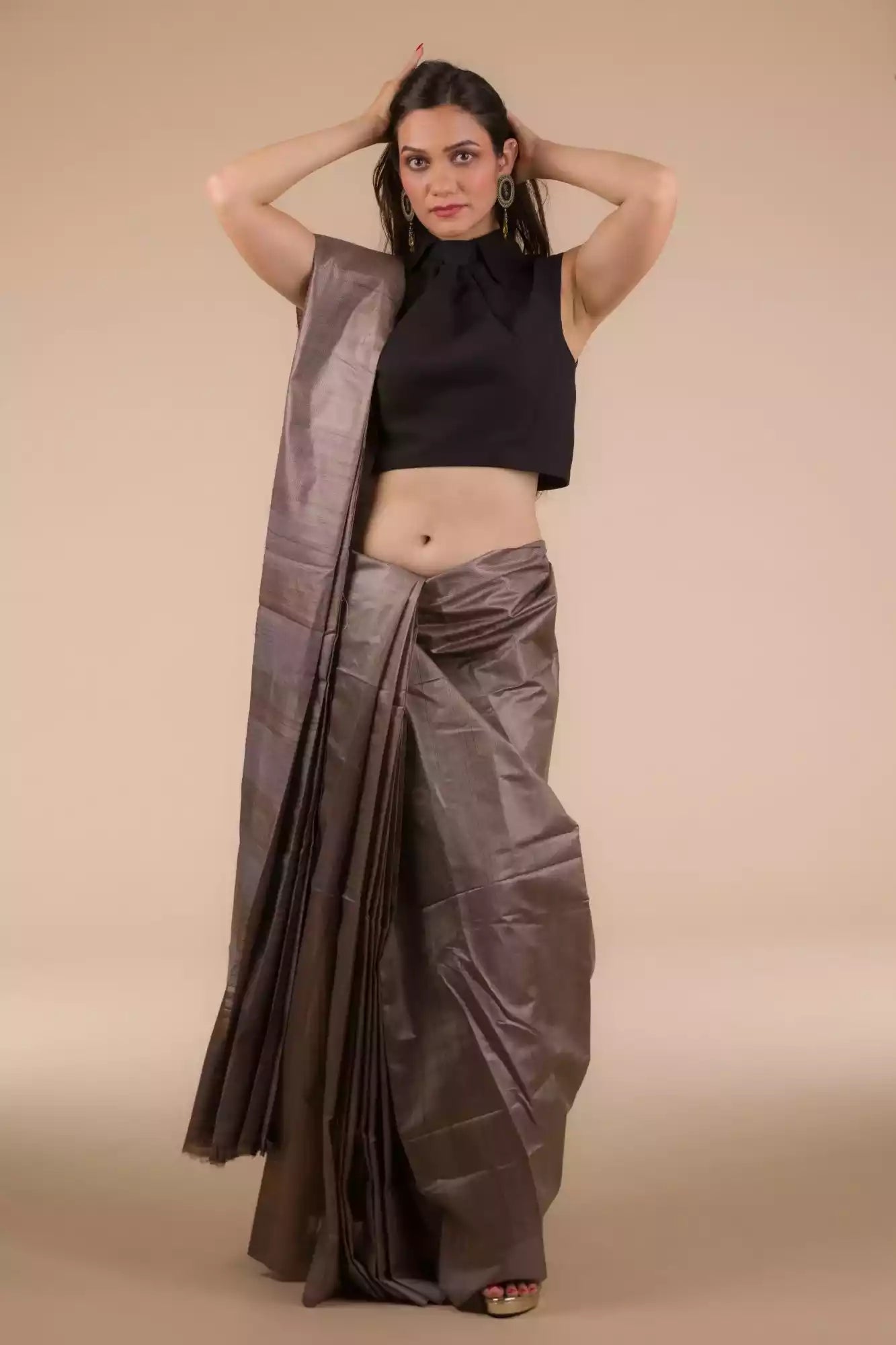 a woman with short hair is posing for the camera and she is wearing a purple saree and a black blouse