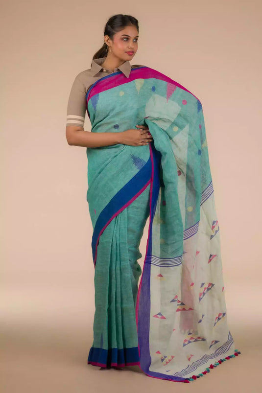 A lady in Light sea green Jamdani hand weaving In Pure Linen Saree standing against a beige background.