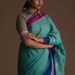 Aesthetically pleasing picture of a lady in a Light sea green Jamdani hand weaving In Pure Linen Saree