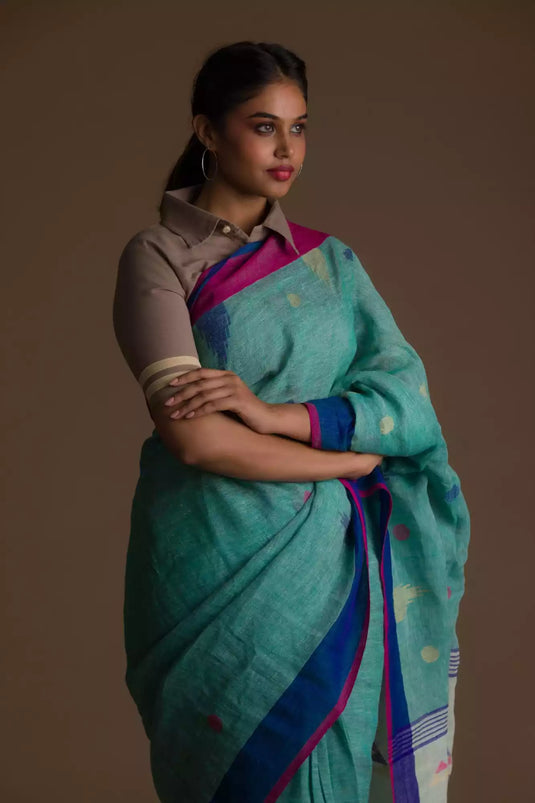 Aesthetically pleasing picture of a lady in a Light sea green Jamdani hand weaving In Pure Linen Saree