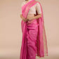 a beautiful woman wearing Pretty Pink Plain In Pure Linen Saree, women workwears is posed in front of a tan background