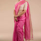 A lady in Pretty Pink Plain In Pure Linen Saree standing against a beige background.