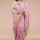 a beautiful woman wearing Baby pink Jamdani hand weaving In Pure Linen Saree, women workwears is posed in front of a tan background