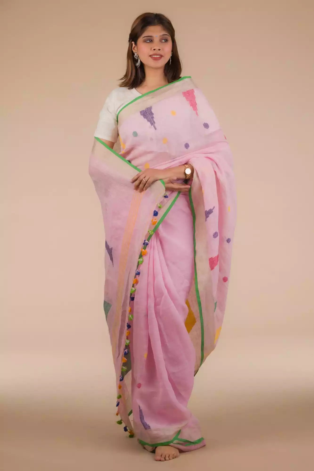 a beautiful woman wearing Baby pink Jamdani hand weaving In Pure Linen Saree, women workwears is posed in front of a tan background