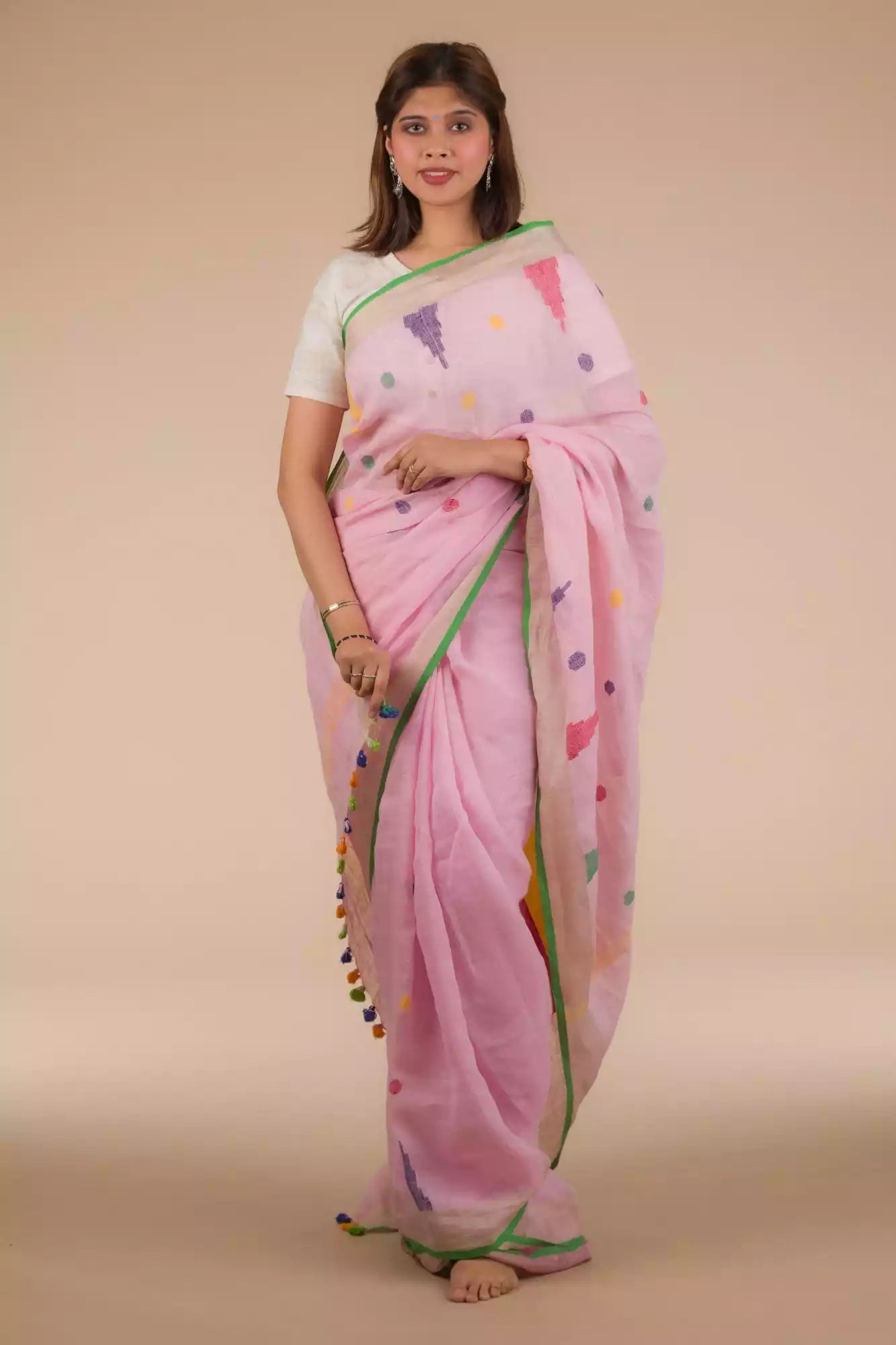 A lady in Baby pink Jamdani hand weaving In Pure Linen Saree  standing against a beige background.