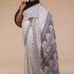 A pretty lady in Baluchari Resham Thread Linen Saree in White, a office wear for women