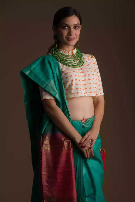 Aesthetically pleasing picture of a lady in a Sea Green and Red Border Plain In Pure Tussar with Ghicha Border Saree