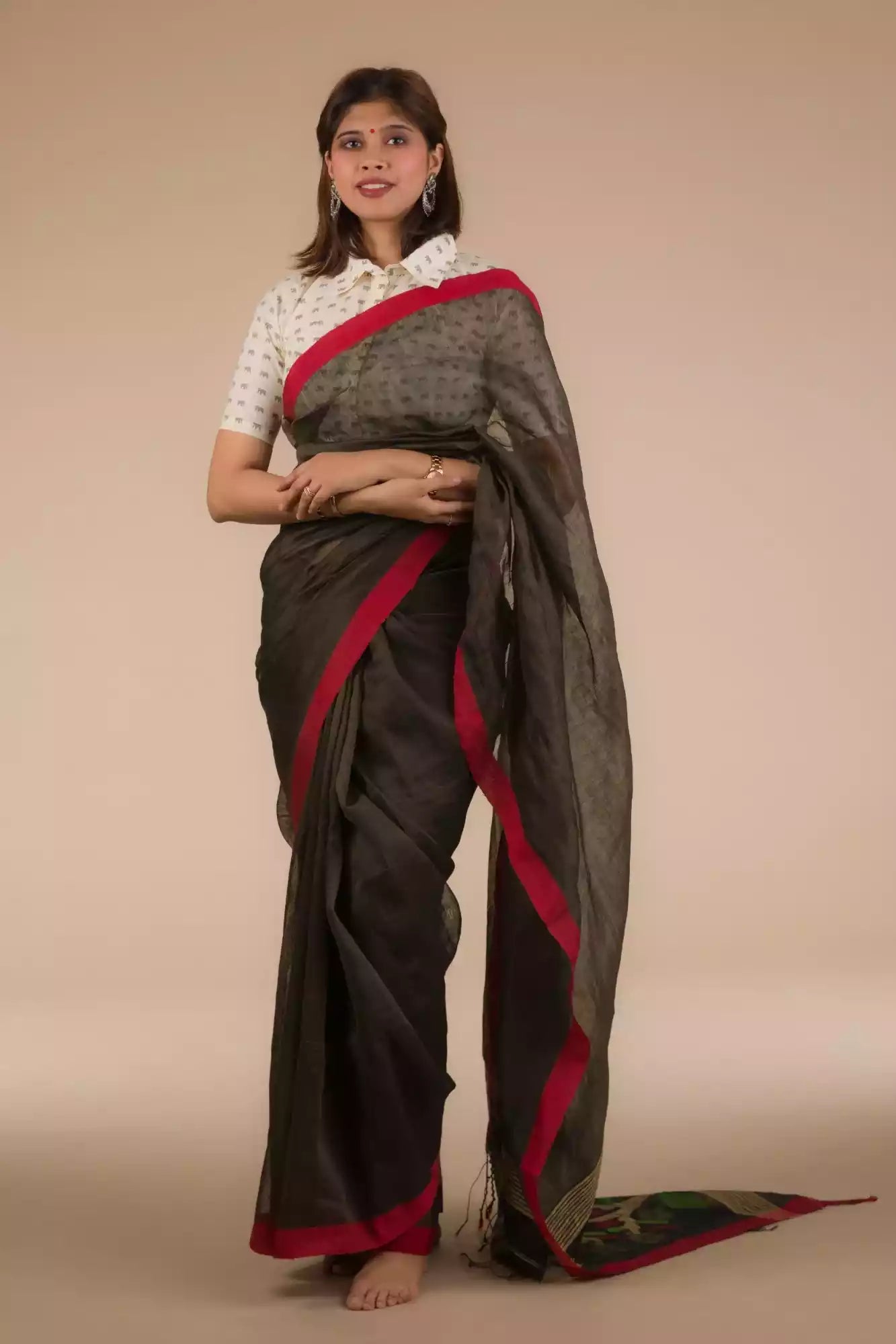 a beautiful woman with short hair wearing a chocolate brown saree with collared blouse 