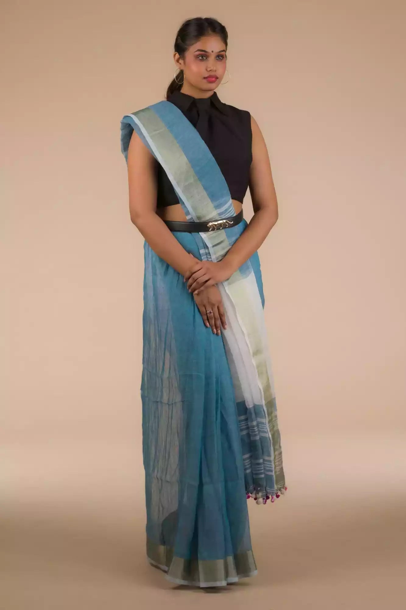 woman wearing a blue saree and a black blouse with stripes at the border and a belt