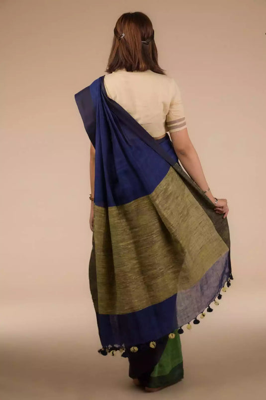 back look of a woman wearing a multicolor saree with brown blouse and gold accents on the border, flaunting the loose end of her saree
