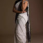 a woman in a white saree with black stripes on it