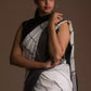 an attractive woman wearing white saree with black stripes on it