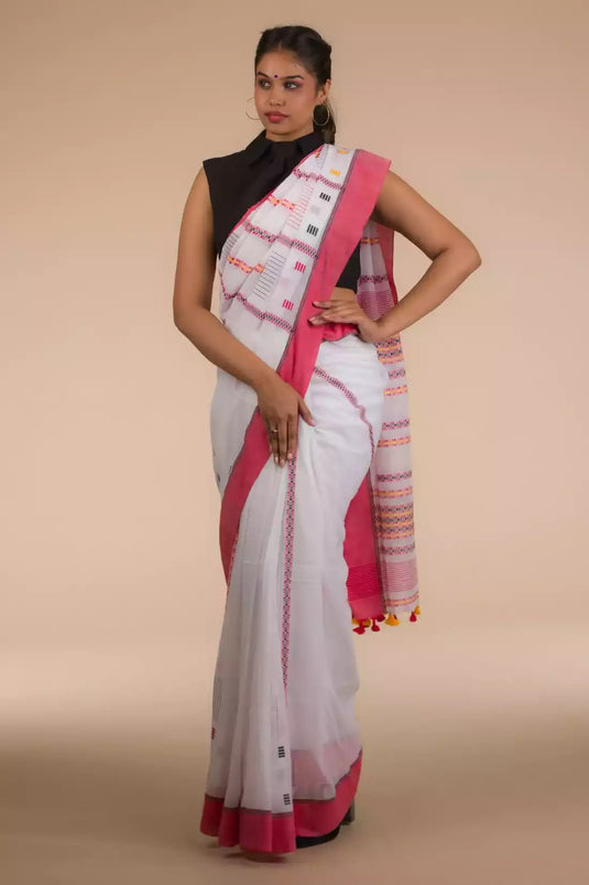 A lady in White & Red In Cotton Saree standing against a beige background