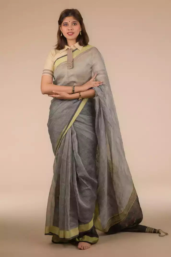 a beautiful woman wearing a Grey Silk Linen Jamdani hand weaving Saree, women workwears is posed in front of a tan background