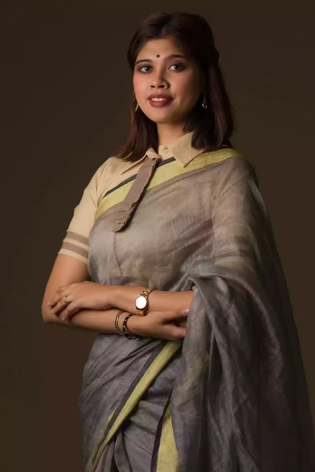 A lady in Grey Silk Linen Jamdani hand weaving Saree standing against a beige background