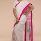 a woman in a white saree with pink polka dot work on it and the bottom half