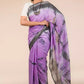 A lady in Purple Shibori In Cotton Viscose Saree standing against a beige background