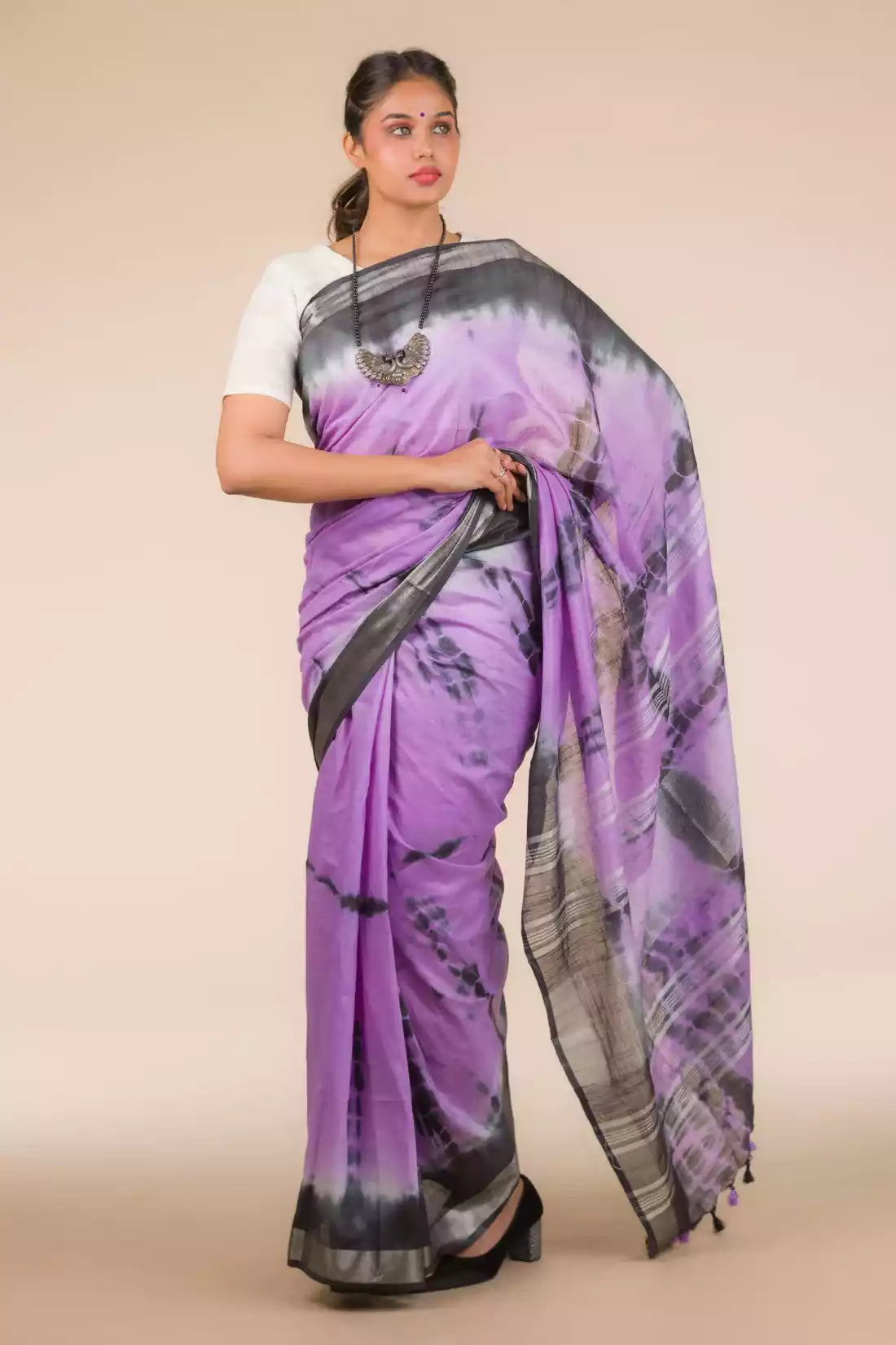 A lady in Purple Shibori In Cotton Viscose Saree standing against a beige background