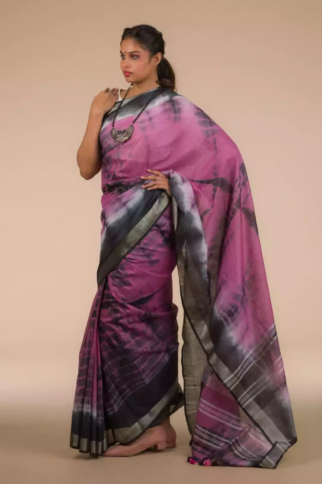 A lady in Shibori In Cotton Viscose Saree standing against a beige background