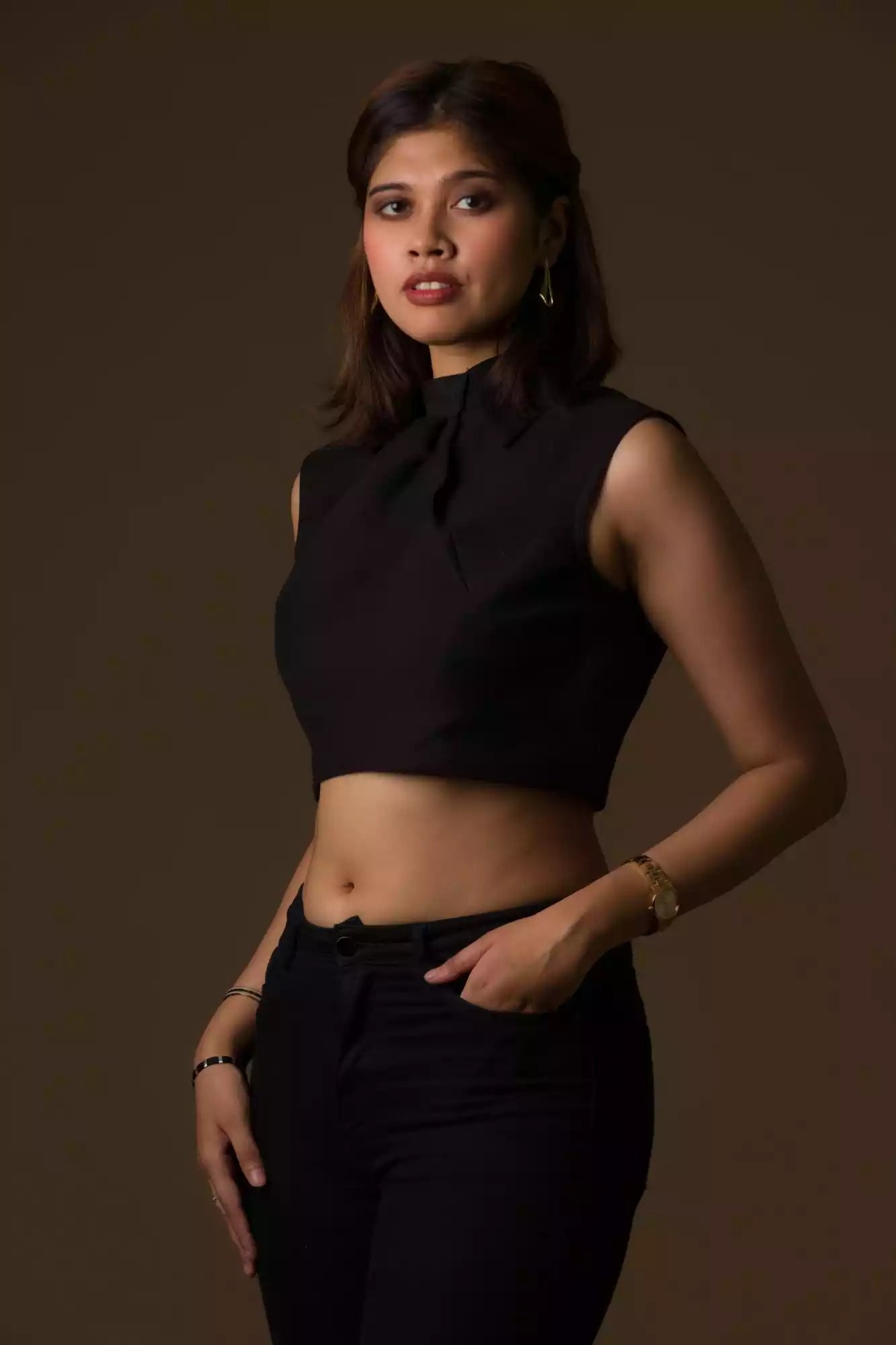 A pretty lady in  Black Cotton Tie sleeveless blouse In Pure Cotton, a office wear for women