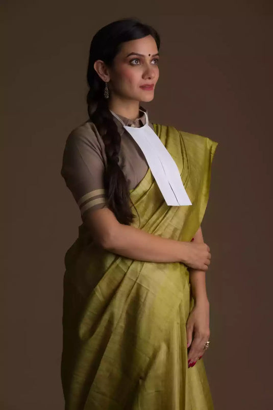 Aesthetically pleasing picture of a lady in Olive Green Plain In Pure Tussar Saree, womens workwear