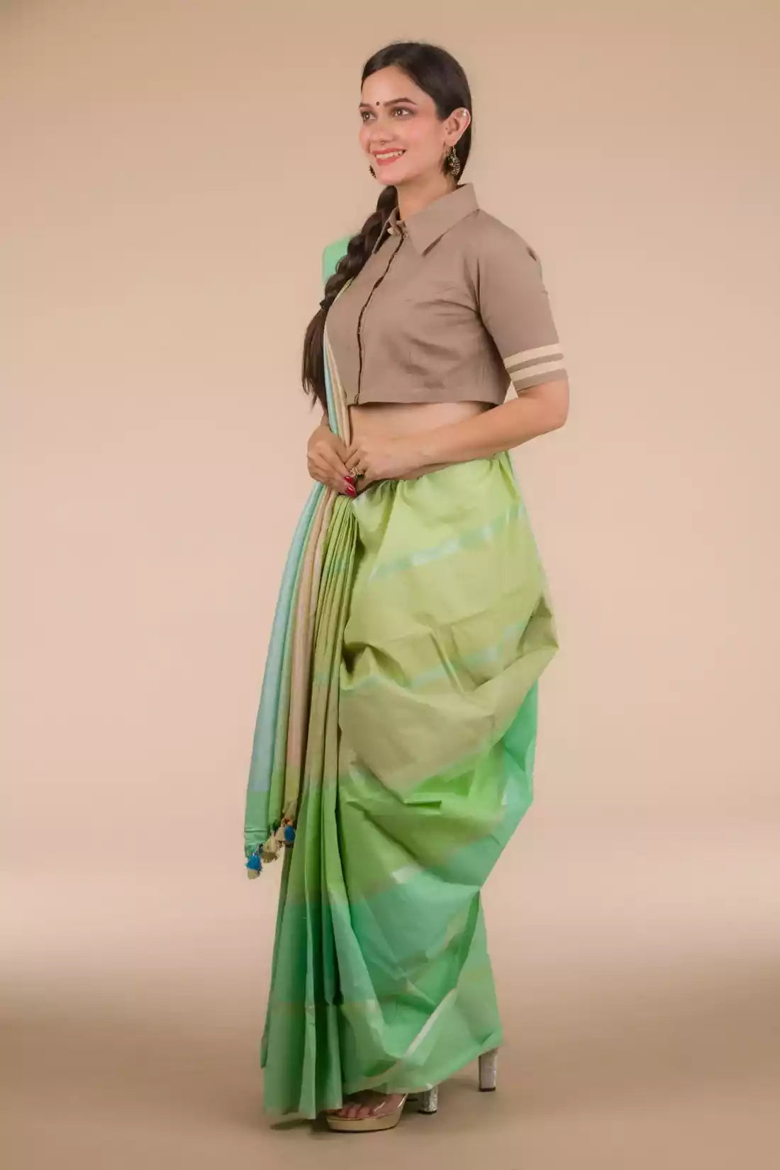 A lady in Horizontal stripes Multicolor In Pure Cotton Saree, womens workwear standing against a beige background
