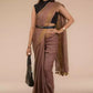 a woman in a chestnut brown in pure linen saree standing which women workwear in front of a beige backdrop
