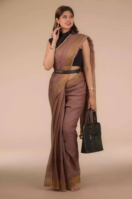 It is a portrait of lady wearing a linen saree and holding a bag 